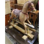 A beautifully restored 19th century child's rocking horse, pony skin, with complete leather saddle a