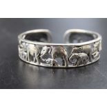 A 20th century silver bangle, with pierced and cast elephant decoration, 4.8g