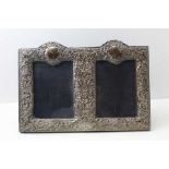 A Victorian design double silver photograph frame, London 2000, with embossed floral and leaf decor