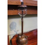 A brass Tilley lamp with original glass shade