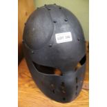 An enclosed full face iron helmet.