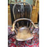 19th century Elm seated comb and horseshoe backed country armchair with well figured seat.