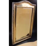 An early 20th century silver framed table mirror, inset bevelled glass, the back with easel stand, C
