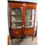 An Edwardian mahogany inlaid display cabinet with two fancy bar glazed doors.