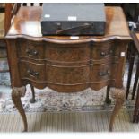 A reproduction burr walnut serpentine fronted chest of two drawers