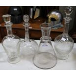 Three decanters with stoppers and a conical carafe