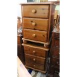 A pair of pine three drawer bedside cabinets
