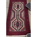 A geometric patterned woven floor rug, 93cm x 179cm