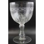 A large Victorian blown glass goblet, the bowl with wheelcut decoration, hollow baluster stem on a c