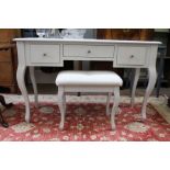 A Laura Ashley modern white three drawer dressing table, with matching stool