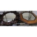 A carved floral framed mirror and one other.