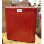 A vintage red painted petrol can with brass cap.