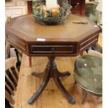 A reproduction leather inset octagonal top centre table, 66cm high, 60.5cm in diameter