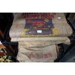 A selection of hessian sacks, some with advertising logos.