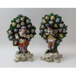 A pair of ceramic bocage backed figures, bearing Derby mark, probably Sampson of Paris, 25cm