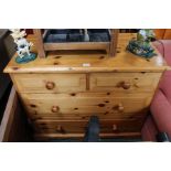 A pine chest of four drawers.