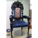 A Continental carved wooden framed throne armchair, with facemask crest