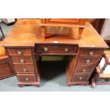 A Georgian design knee hole desk, cross banded decoration fitted with nine drawers. 96cm wide