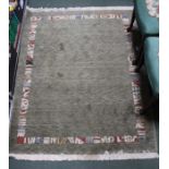 A small woven woolen floor rug, green ground