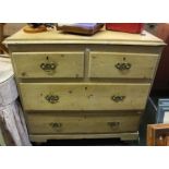 A 19th century pine chest of two short over two long drawers. Brass handles on turned feet 97 cm wi