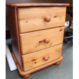 A pine bedside cabinet three drawer.