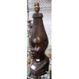 A carved African wooden head formed as a table lamp