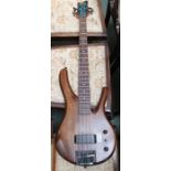 A Fenix short scale bass guitar, the natural wooden body fitted with single pick up