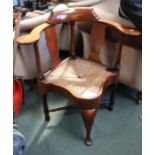 A Victorian walnut horseshoe backed corner chair, with rush seat