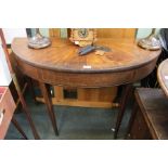 A 19th century demi-lune card table with decorative inlaid top and apron