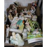 A box containing a selection of ceramic figurines to include Staffordshire