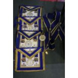 A case containing Four Masonic provincial lodge aprons and three jewelled collars