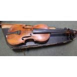 An unnamed antique violin having one piece back with a mid 20th century unnamed bow