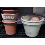 A small selection of terracotta pots with risers