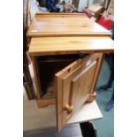 A pine bedside cupboard.