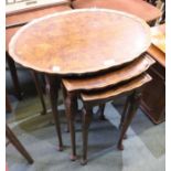 A reproduction walnut piecrust edged nest of three tables