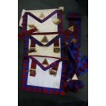 A case containing three Masonic provincial chapter aprons and two chapter sashes