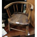 A rustic horseshoe backed toddlers chair, with solid seat