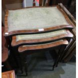 A reproduction mahogany nest of three tables