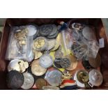 A tin of coins and medallions, some yellow metal some white metal