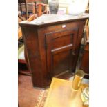 A George III oak hanging corner cabinet, 105cm high