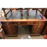 A mahogany twin pedestal writing desk c.1900, fitted nine drawers with brass handles, 120cm wide