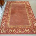 A terracotta ground rug, 276cm x 176cm