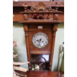 An early 20th Century Mahogany Viennese style hanging wall clock with pendulum and key, 90cm
