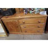 A pine dresser base 19th century single door cupboard and three drawers