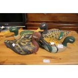 A collection of four hand painted wooden ducks