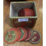 A small hand painted box containing a series of circular Indian hand painted playing tokens