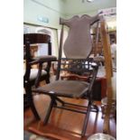 An Edwardian folding chair, fabric upholstered seat, back and arm pads