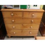 A pine chest of two over three drawers on turned feet, 105cm wide