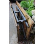 A metal based mobile wooden topped folding garden table