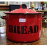 A red enamel bread crock with cover